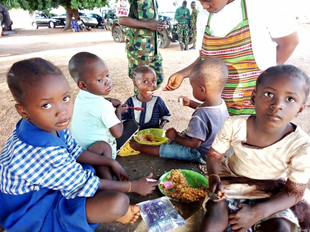 Children seated together sharing a meal